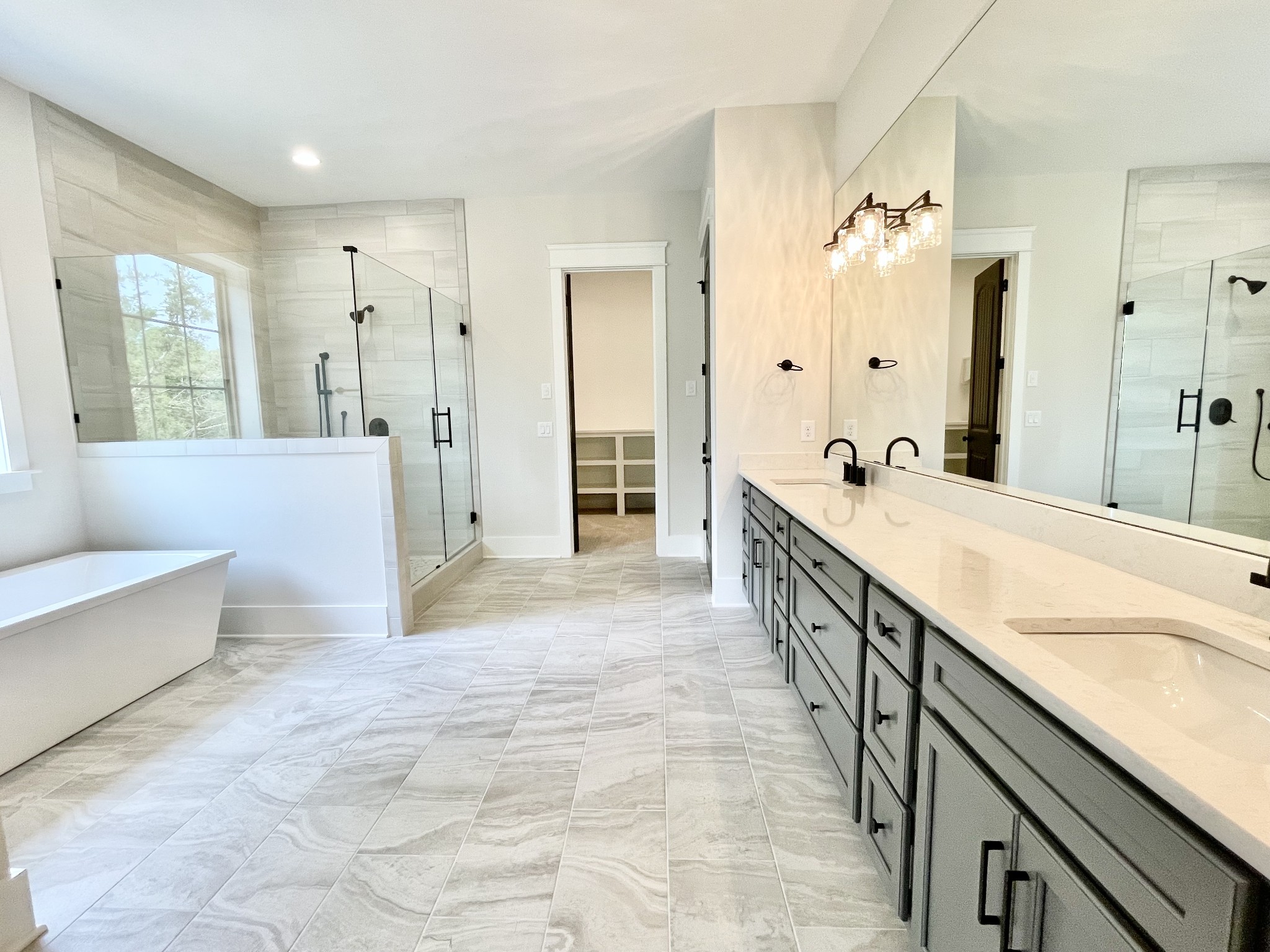 9926 Maupin Road Brentwood, TN 37027 - Photo 51 of 88 a spacious en suite bathroom with a double vanity sink a large mirror and a bathtub