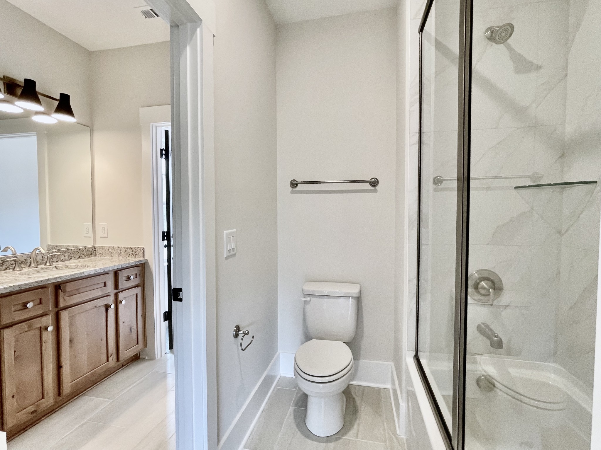 9926 Maupin Road Brentwood, TN 37027 - Photo 70 of 88 a bathroom with a granite countertop toilet a sink and a mirror