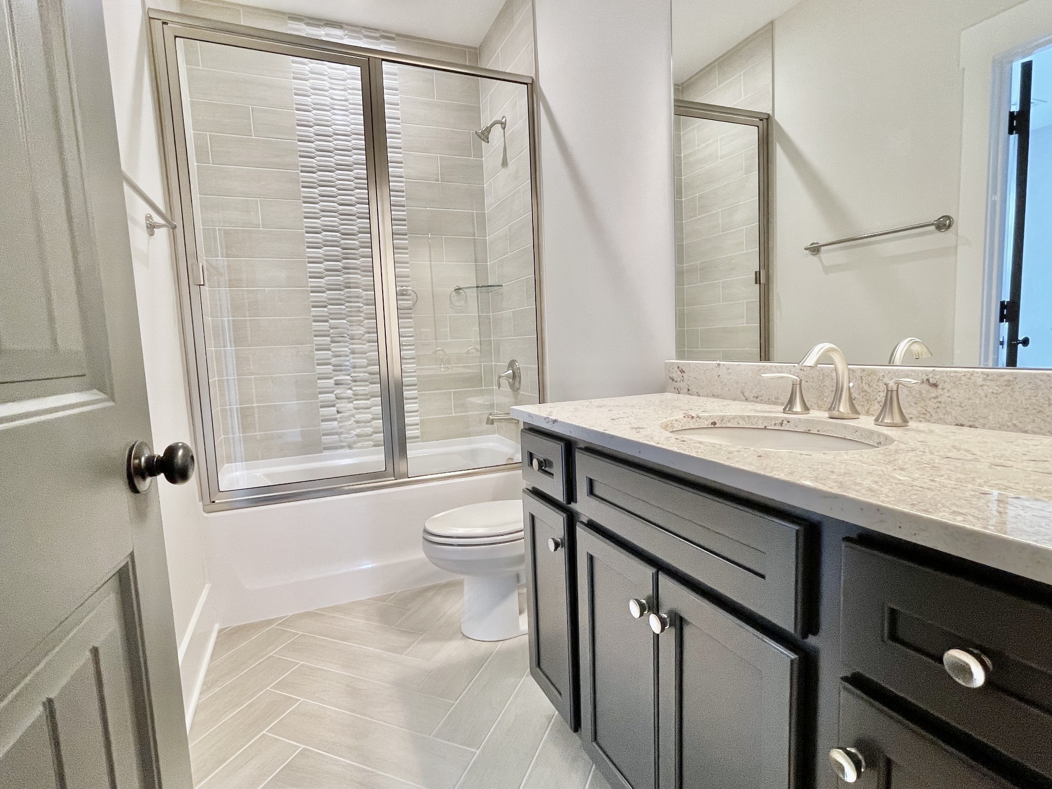9926 Maupin Road Brentwood, TN 37027 - Photo 75 of 88 a bathroom with a granite countertop sink a toilet a mirror and shower
