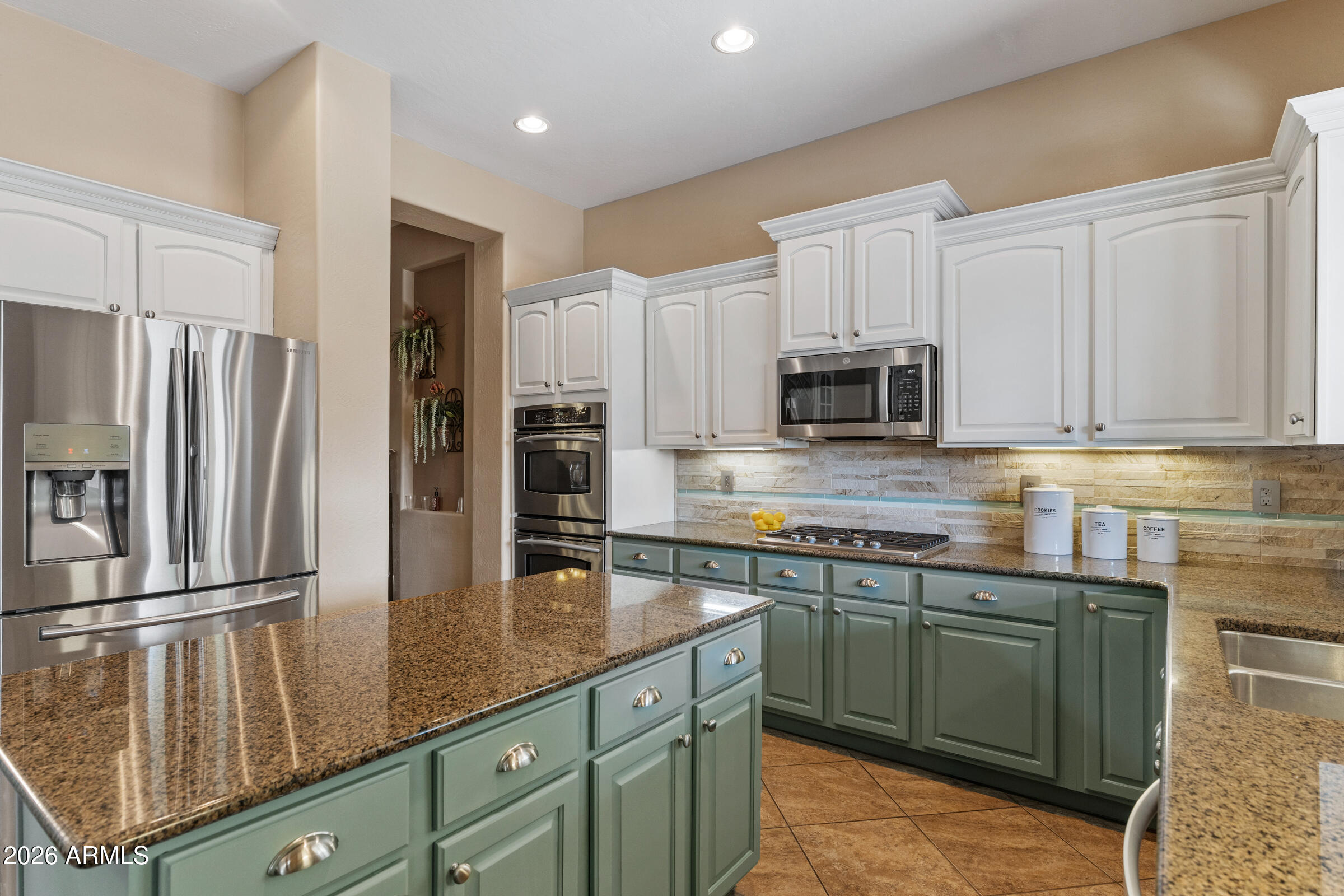 1341 East Macaw Court Gilbert, AZ 85297 - Photo 12 of 49 a kitchen with stainless steel appliances granite countertop a refrigerator sink and microwave