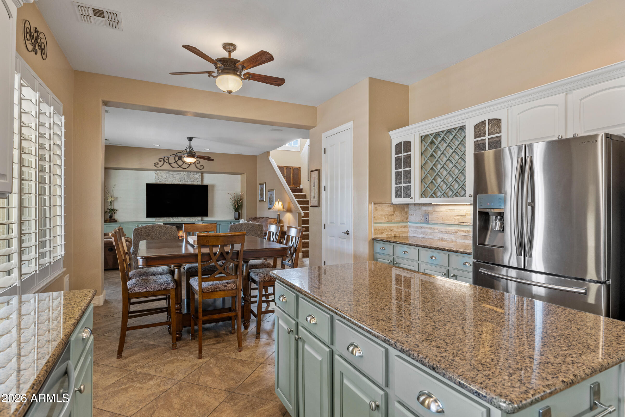 1341 East Macaw Court Gilbert, AZ 85297 - Photo 13 of 49 a kitchen with refrigerator cabinets and dining table