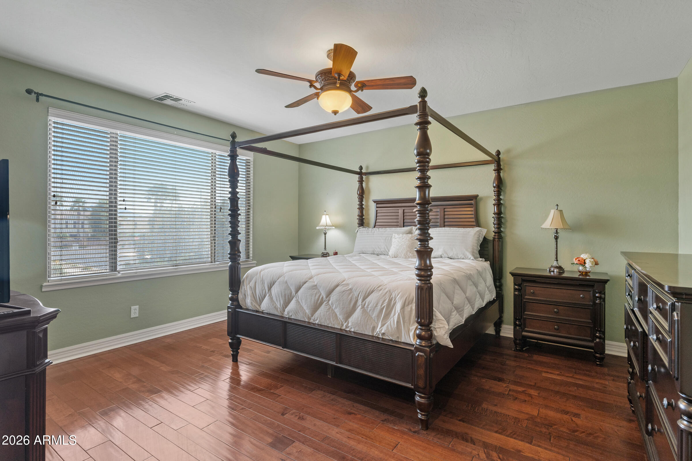 1341 East Macaw Court Gilbert, AZ 85297 - Photo 23 of 49 a bedroom with a bed and wooden floor