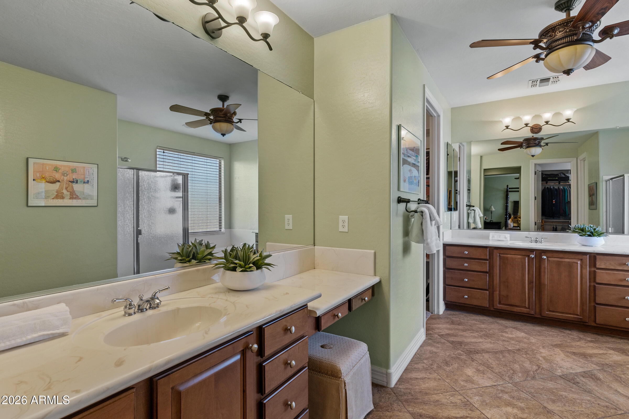 1341 East Macaw Court Gilbert, AZ 85297 - Photo 25 of 49 a bathroom with a granite countertop sink a large mirror and a shower