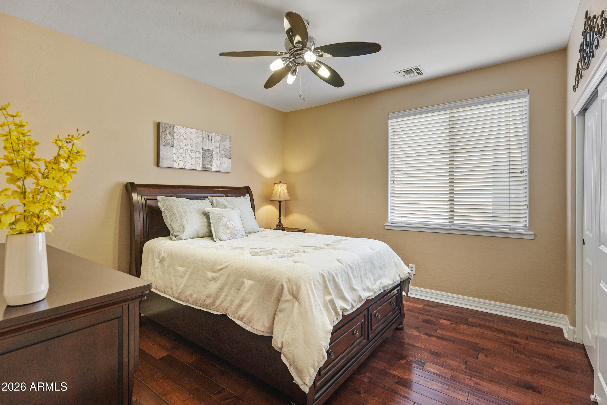 1341 East Macaw Court Gilbert, AZ 85297 - Photo 32 of 49 a bedroom with a bed and a chandelier