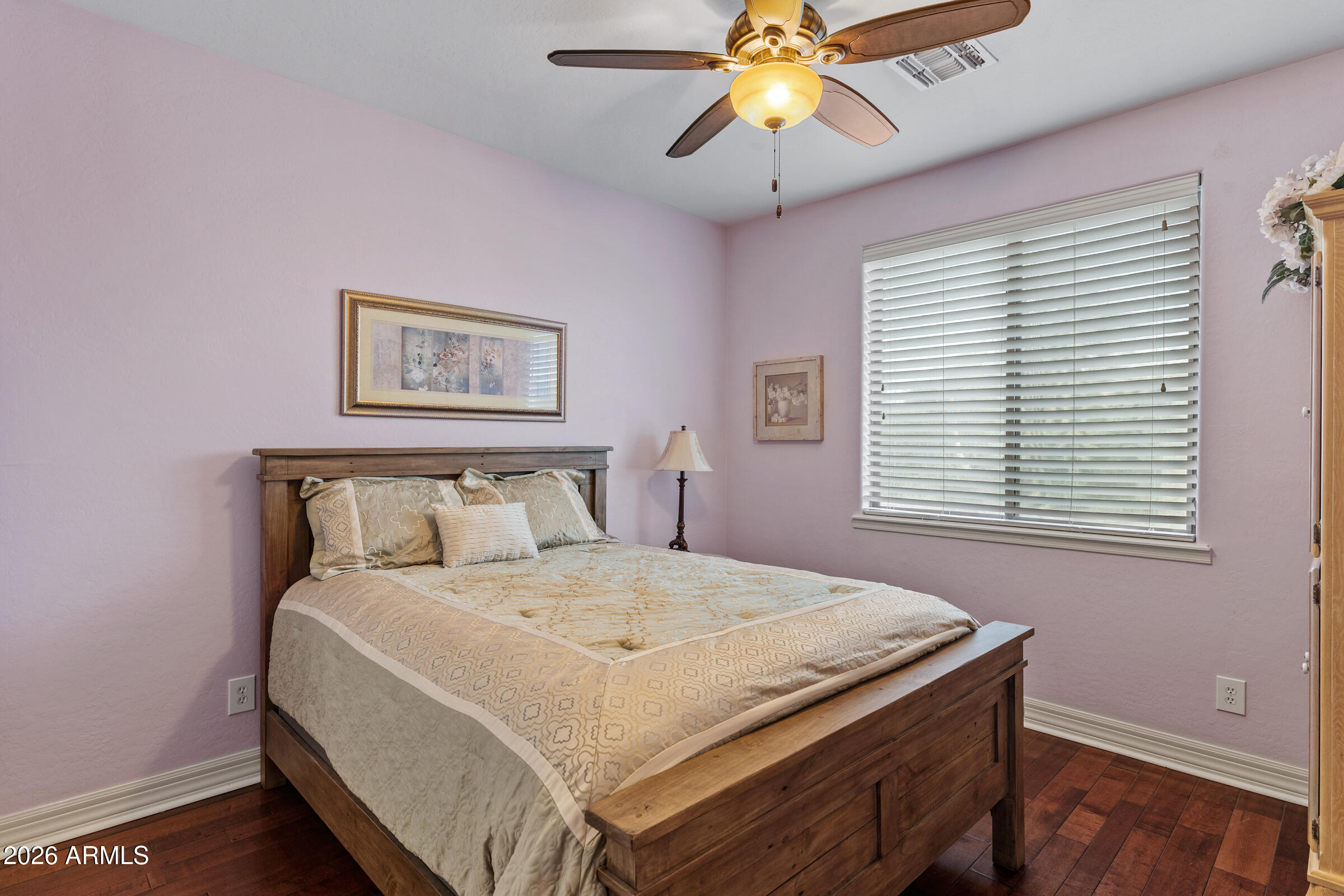 1341 East Macaw Court Gilbert, AZ 85297 - Photo 33 of 49 a bedroom with a bed and a chandelier
