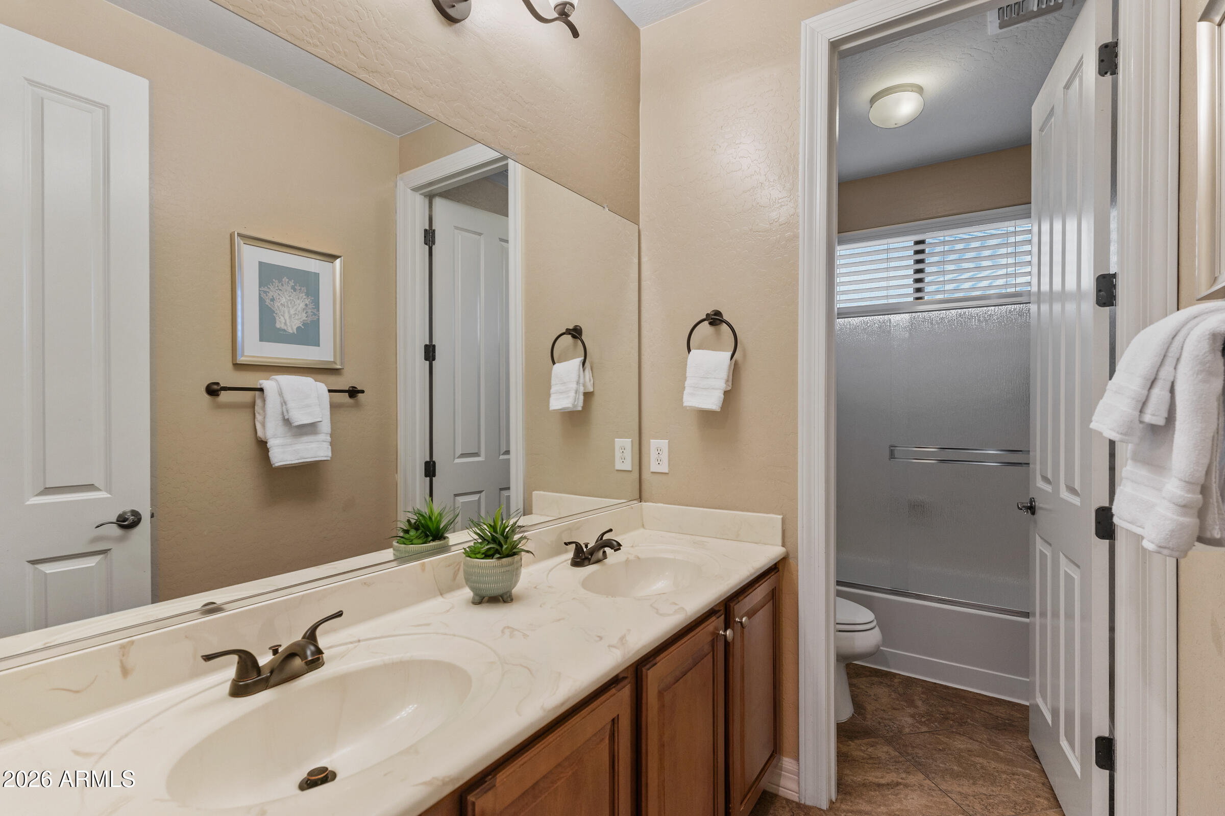 1341 East Macaw Court Gilbert, AZ 85297 - Photo 34 of 49 a bathroom with a tub sink and mirror