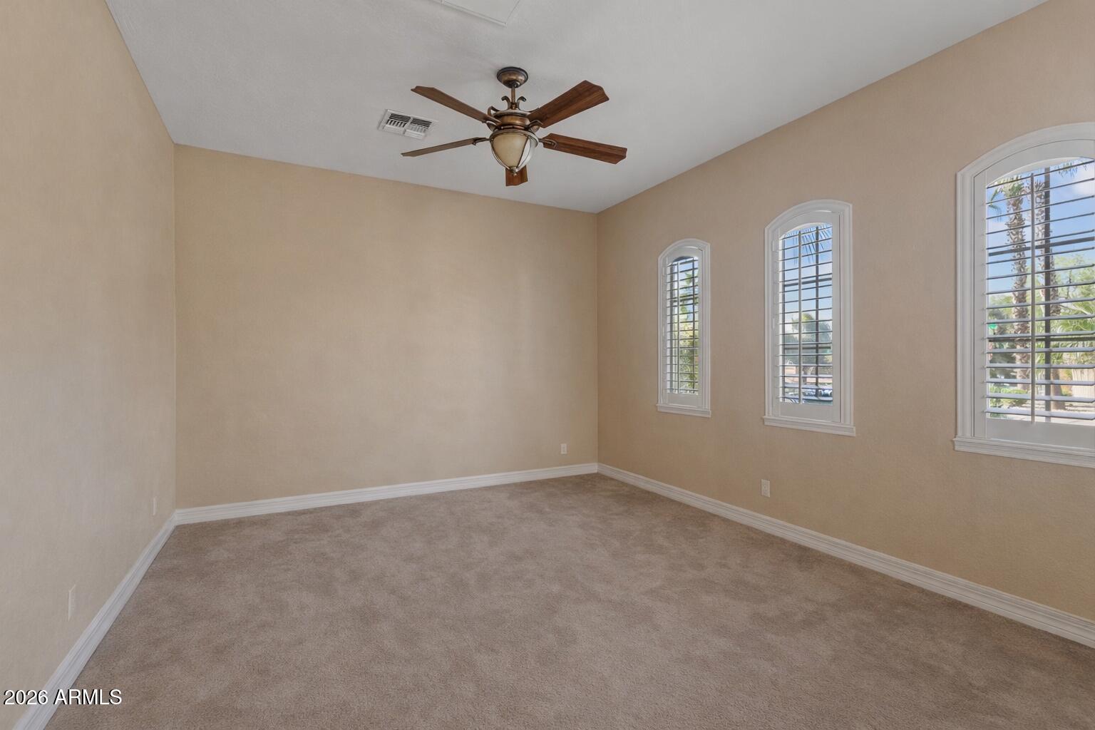 1341 East Macaw Court Gilbert, AZ 85297 - Photo 38 of 49 an empty room with windows and fan view