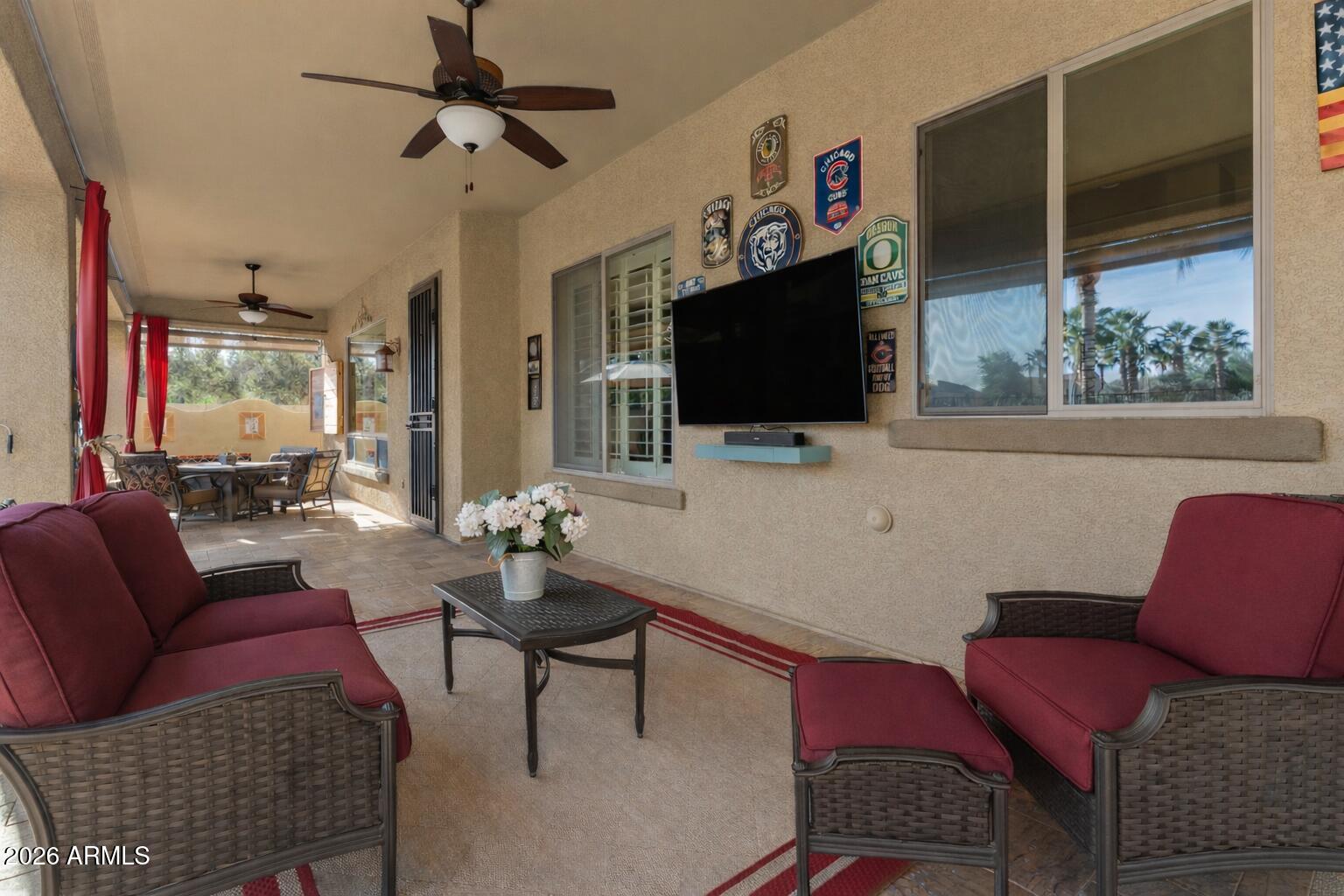 1341 East Macaw Court Gilbert, AZ 85297 - Photo 48 of 49 a living room with furniture a flat screen tv and a window