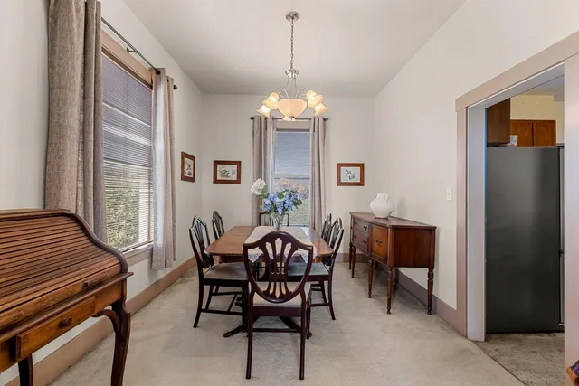 a dining room with furniture and window