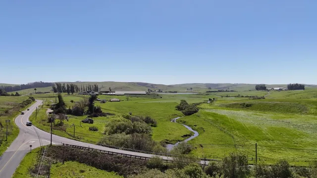 an aerial view of ocean with residential houses