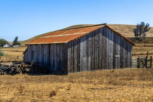 a view of a house with wooden fence