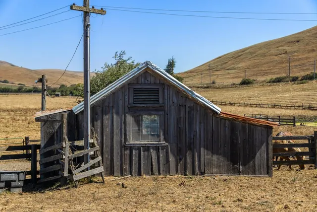 a view of a house with wooden fence