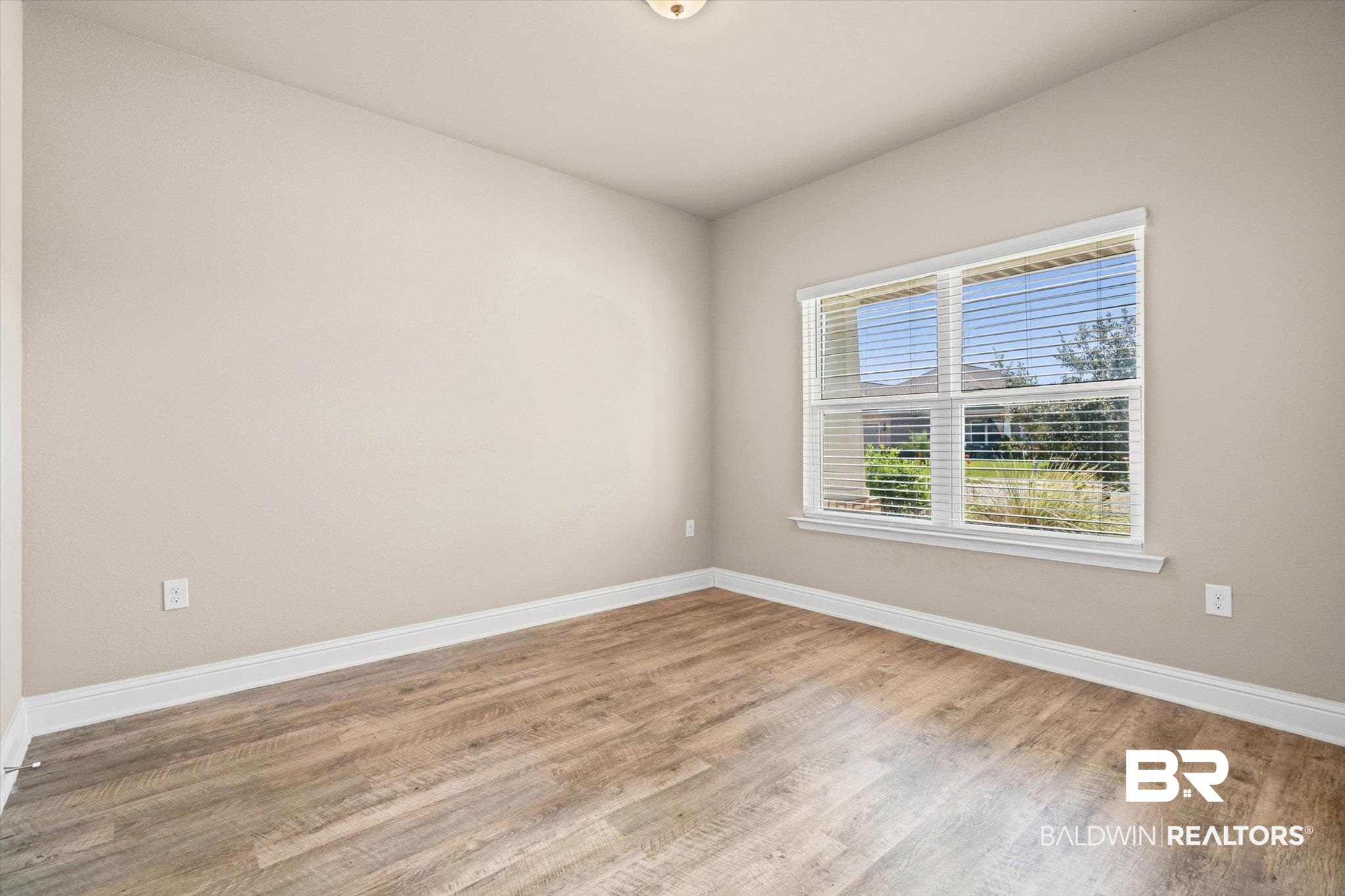 22976 Lieutenant Avenue Foley, AL 36535 - Photo 15 of 30 Spare room featuring baseboards and wood finished floors