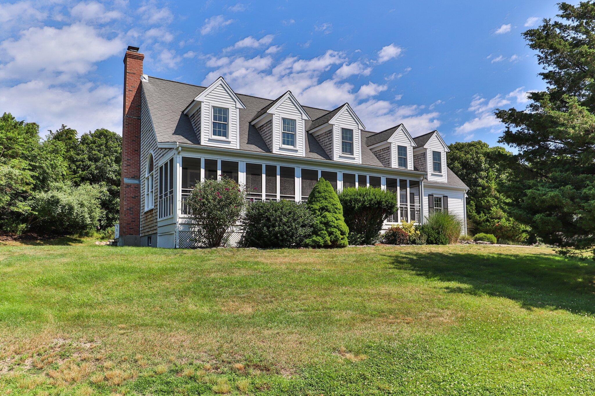 a front view of a house with a garden