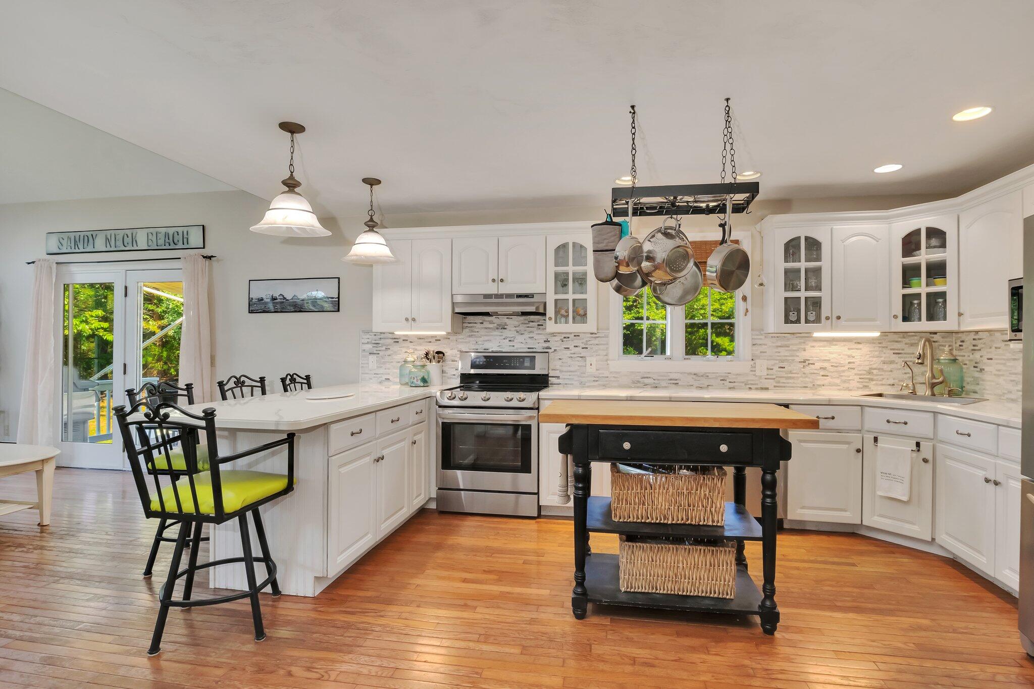 45 Briar Lane West Barnstable, MA 02668 - Photo 13 of 44 a kitchen with stainless steel appliances granite countertop a kitchen island hardwood floor sink stove dining table and chairs