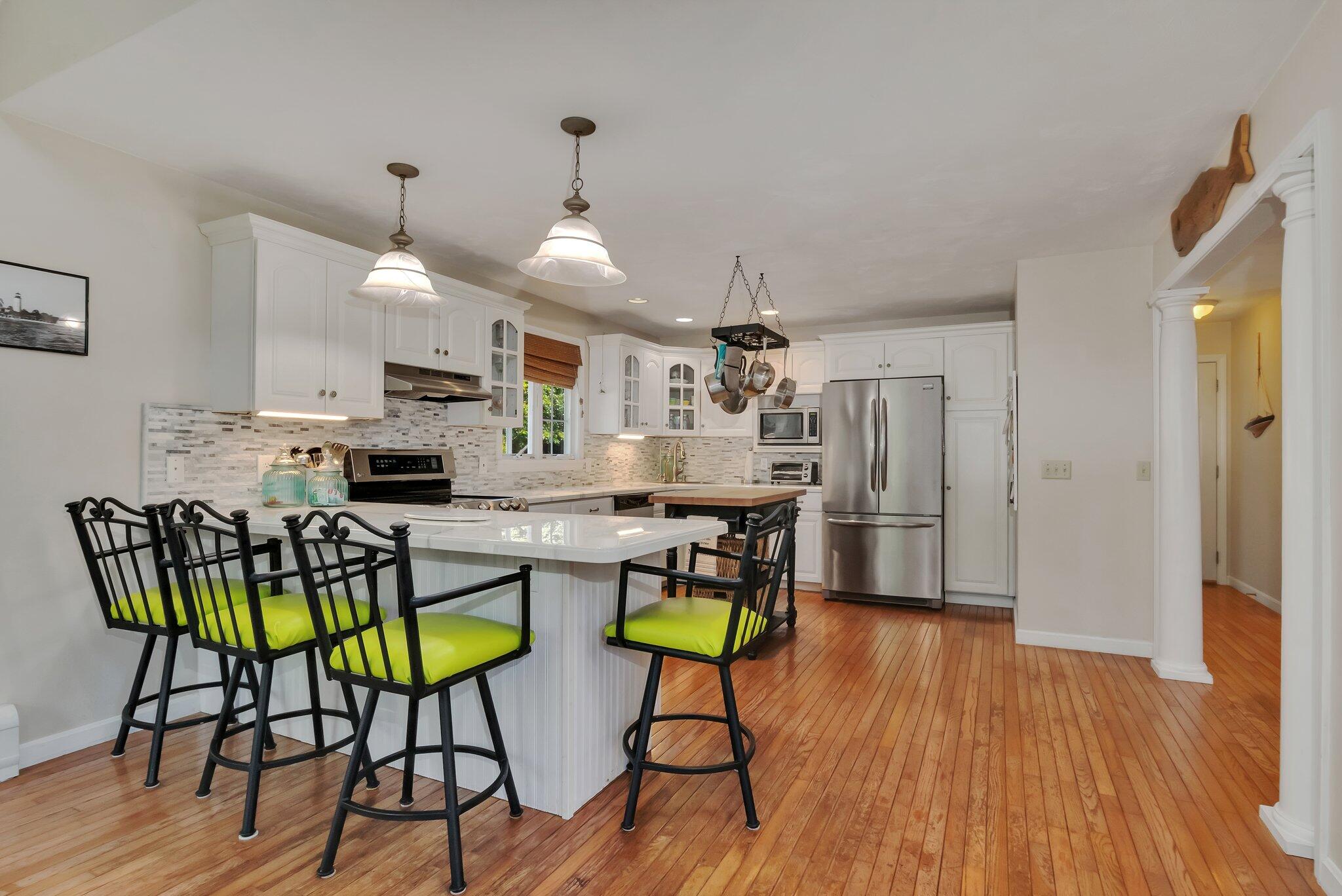 45 Briar Lane West Barnstable, MA 02668 - Photo 14 of 44 a kitchen with stainless steel appliances a dining table chairs refrigerator and microwave