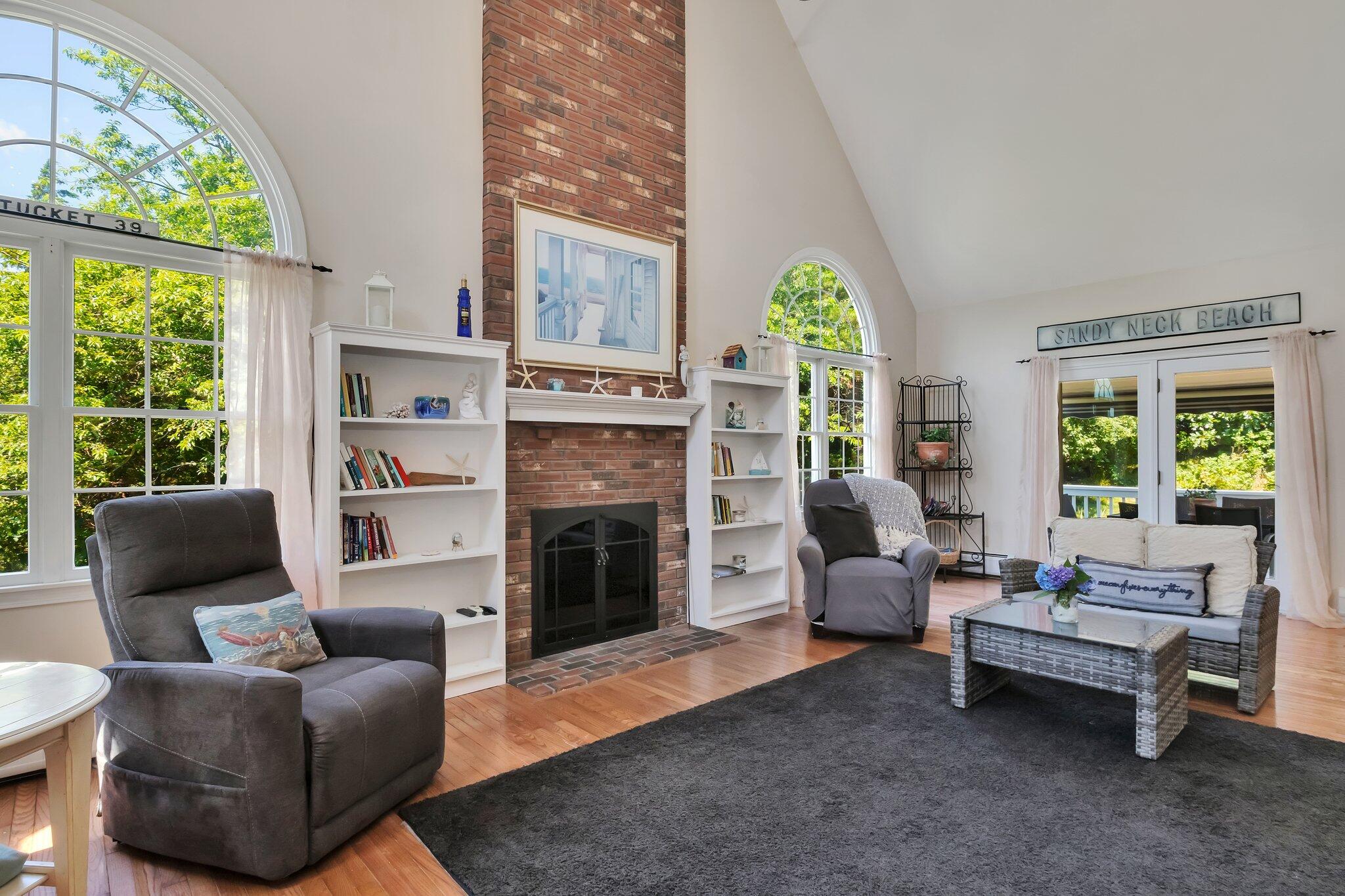 45 Briar Lane West Barnstable, MA 02668 - Photo 16 of 44 a living room with furniture a fireplace and a large window