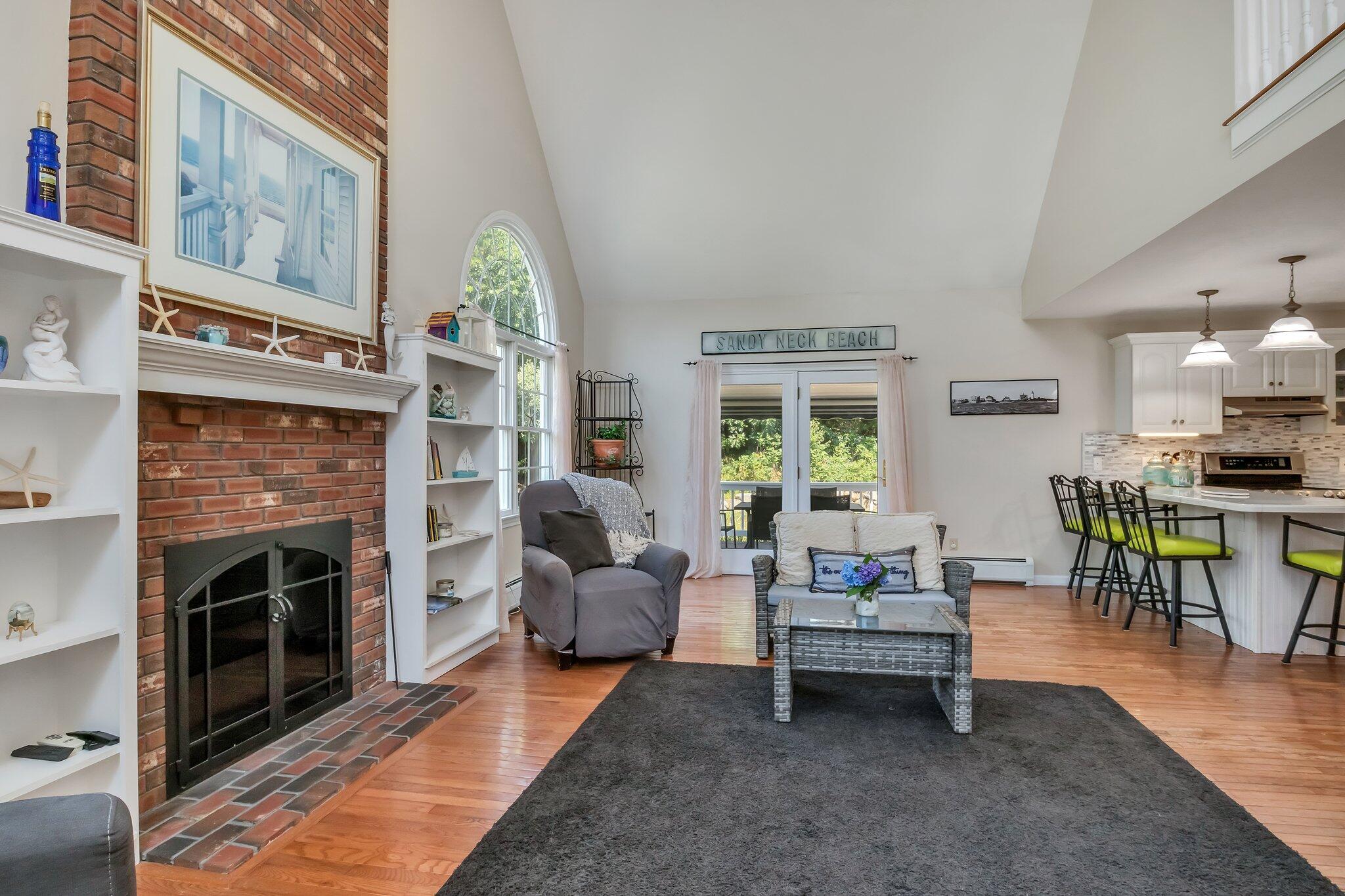 45 Briar Lane West Barnstable, MA 02668 - Photo 18 of 44 a living room with furniture a fireplace and a table