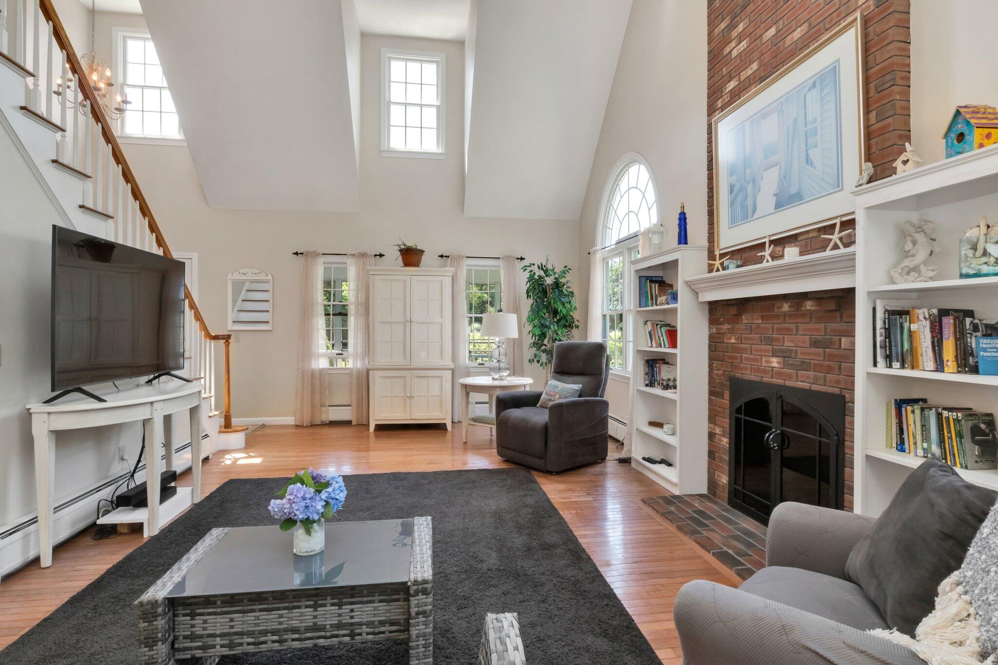 45 Briar Lane West Barnstable, MA 02668 - Photo 19 of 44 a living room with furniture a flat screen tv and a fireplace
