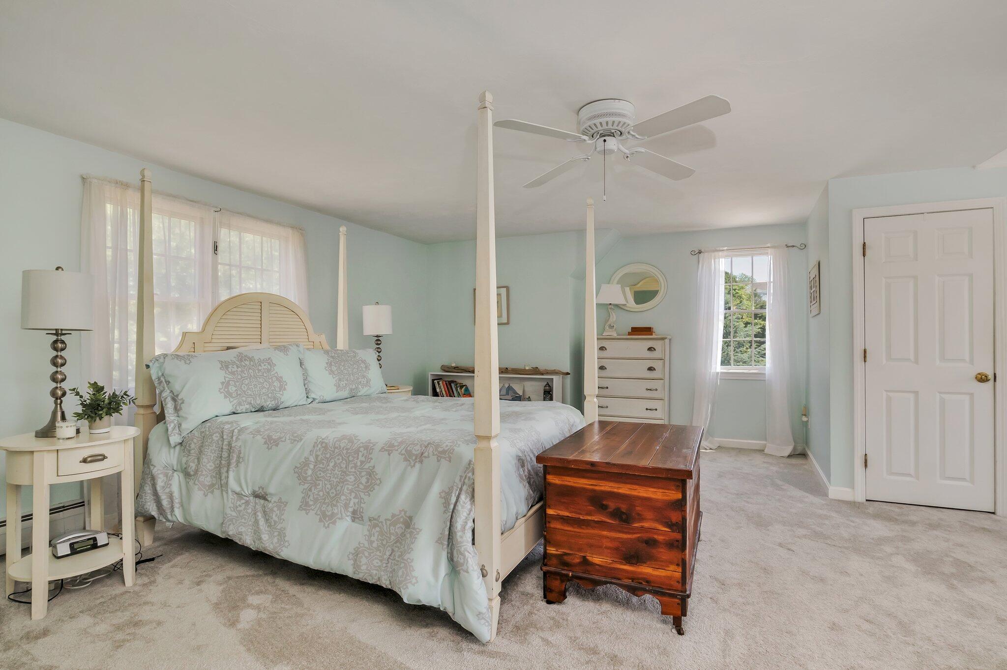 45 Briar Lane West Barnstable, MA 02668 - Photo 26 of 44 a bedroom with a bed and a chandelier