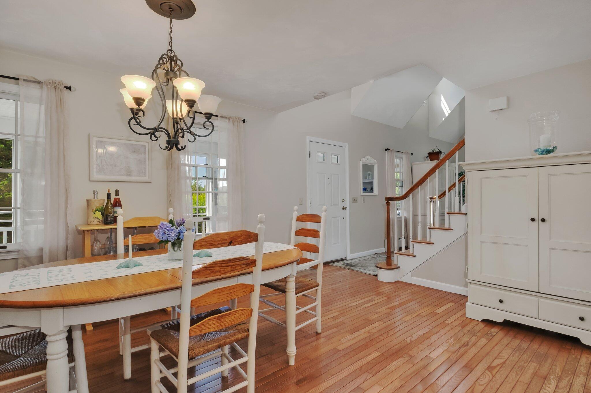 45 Briar Lane West Barnstable, MA 02668 - Photo 10 of 44 a dining room with wooden floor a chandelier a wooden table and chairs