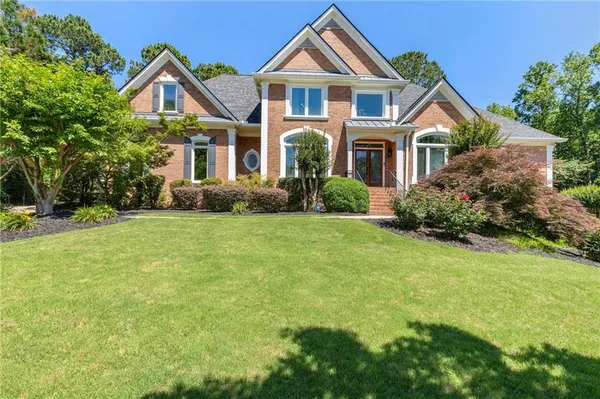 a front view of a house with a yard