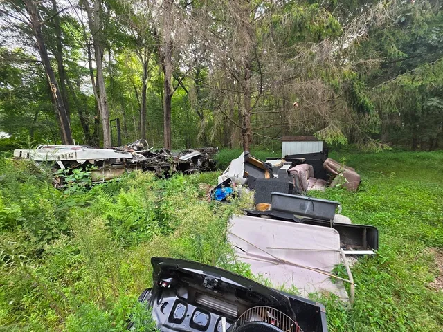 a view of a chairs and table in backyard of the house