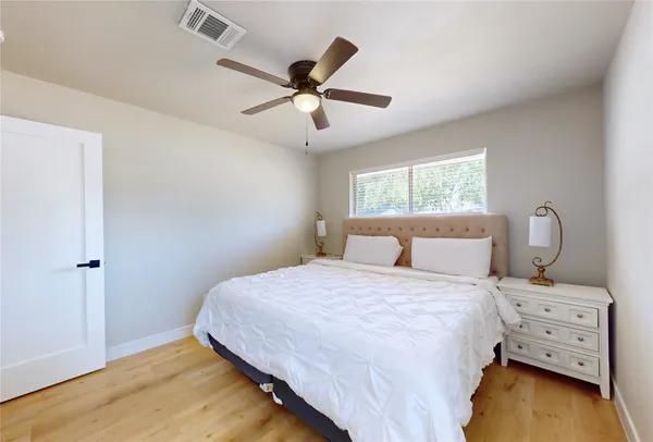 a bedroom with a bed and a ceiling fan