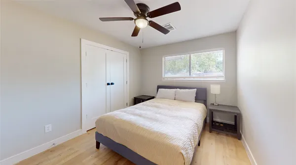 a bedroom with a bed and window