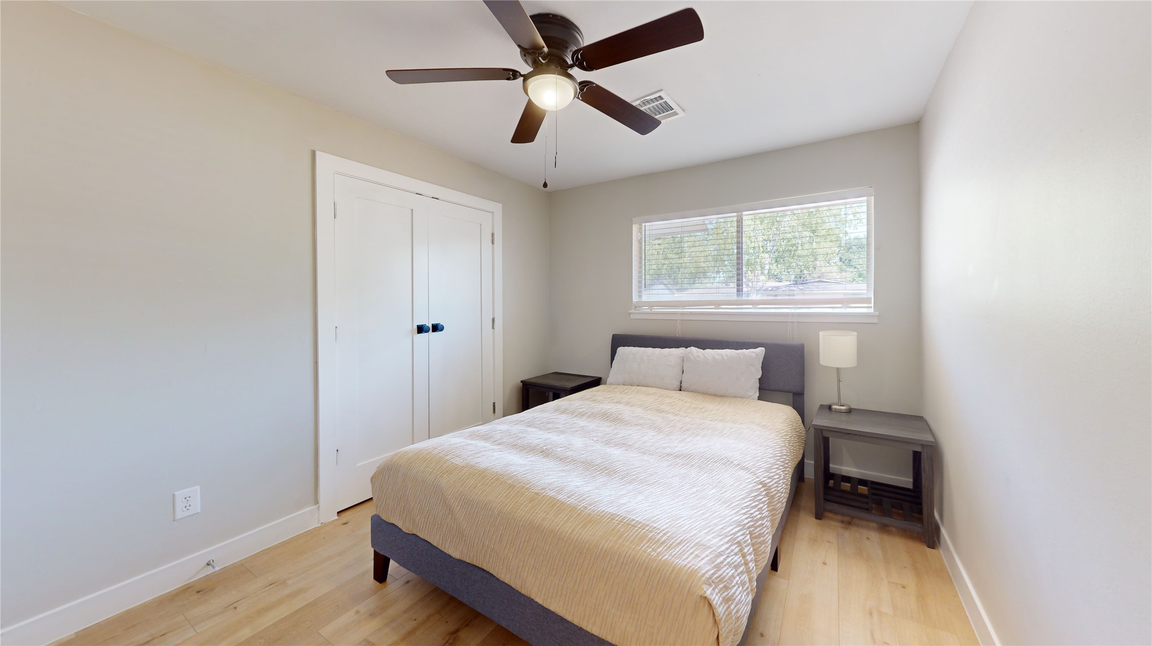 5455 Birdwood Road Houston, TX 77096 - Photo 16 of 26 a bedroom with a bed and a ceiling fan