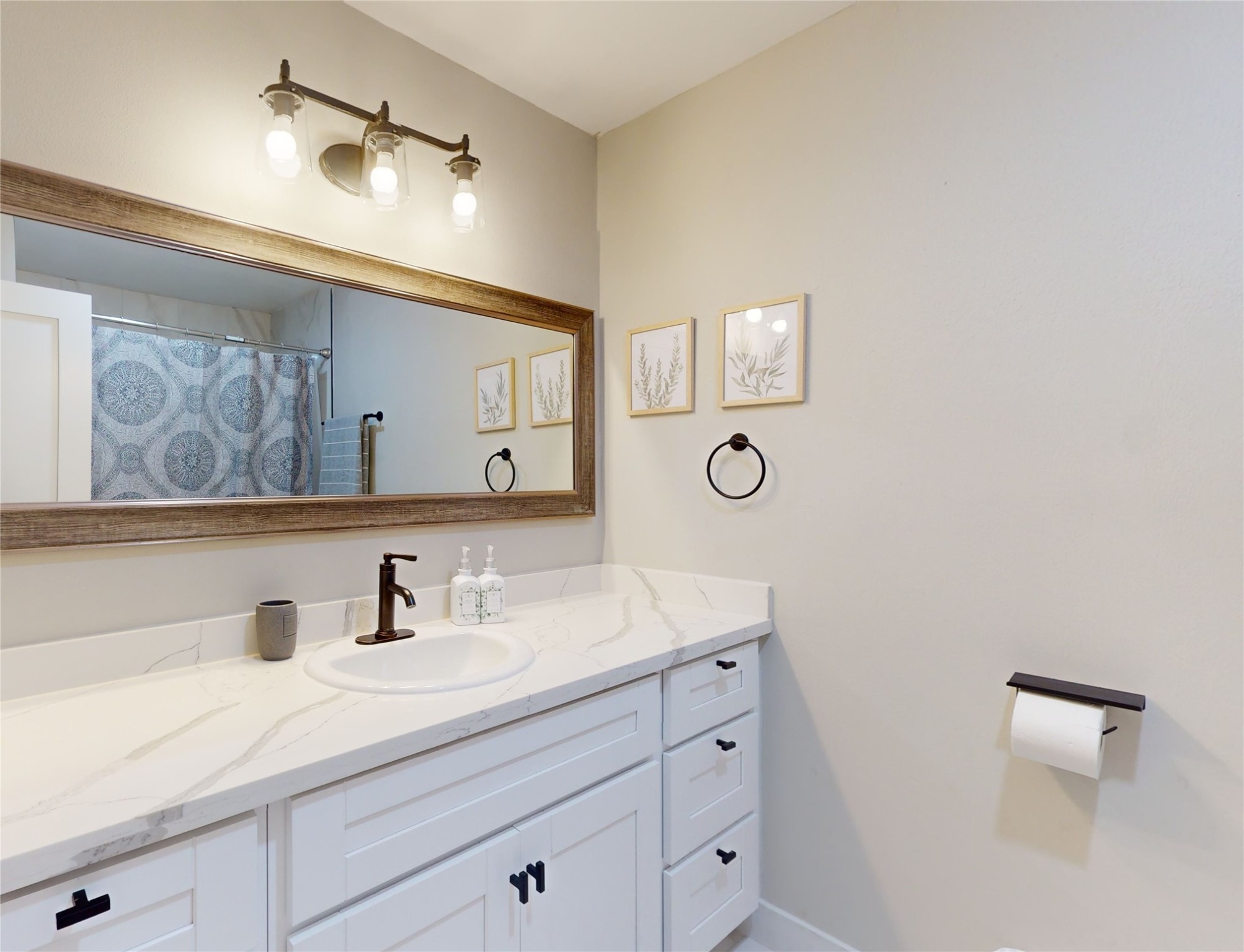 5455 Birdwood Road Houston, TX 77096 - Photo 18 of 26 a bathroom with a sink and a mirror