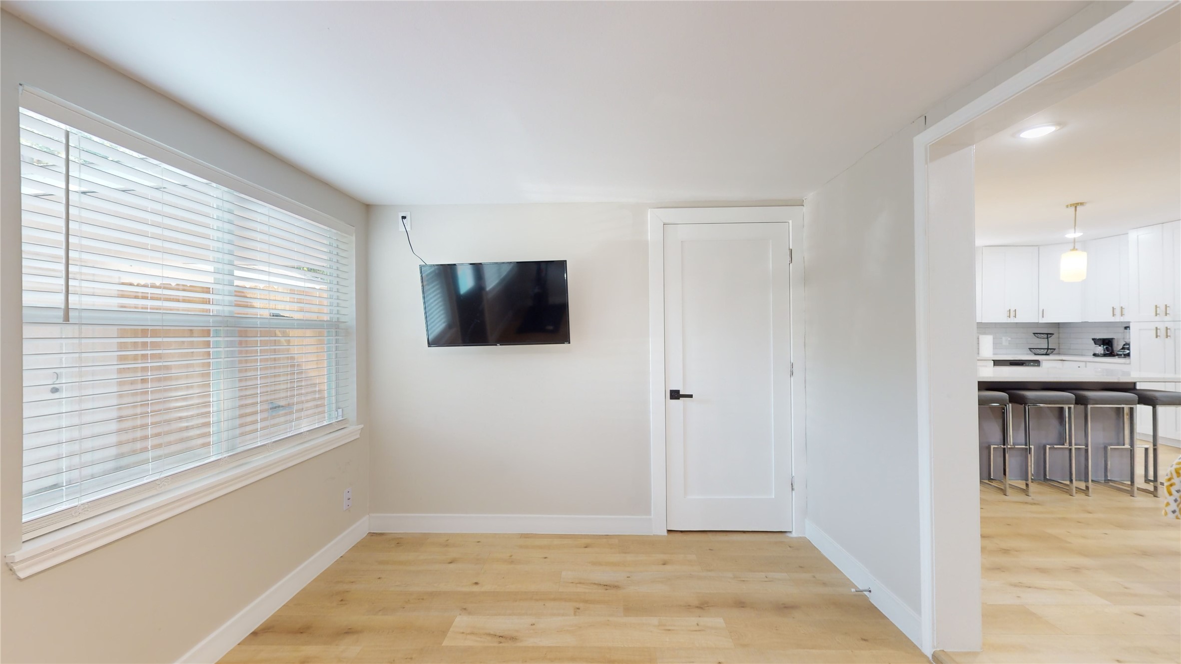 5455 Birdwood Road Houston, TX 77096 - Photo 20 of 26 a view of a livingroom with a kitchen space with wooden floor and a window