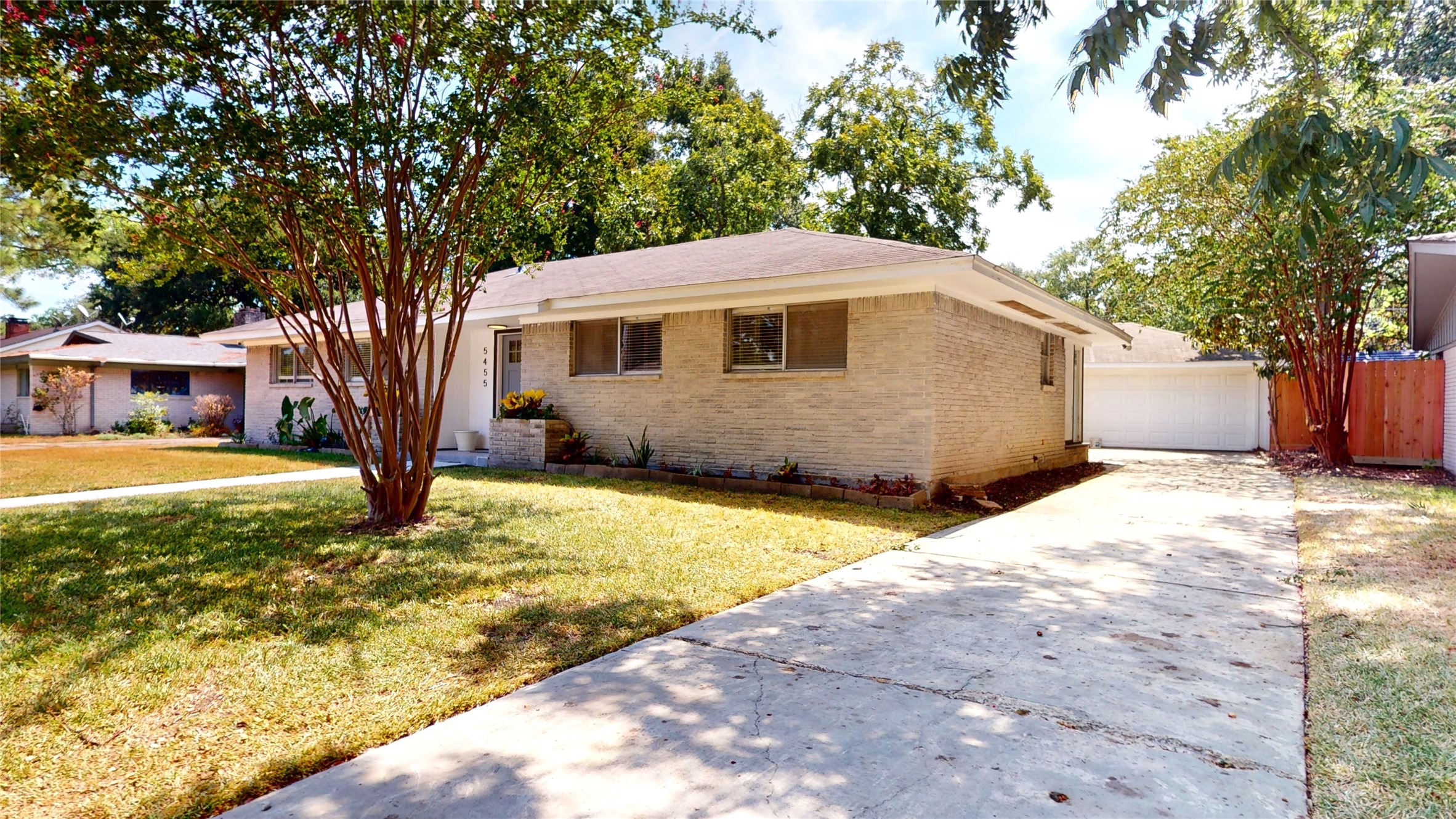 5455 Birdwood Road Houston, TX 77096 - Photo 23 of 26 a yellow house with trees in front of it