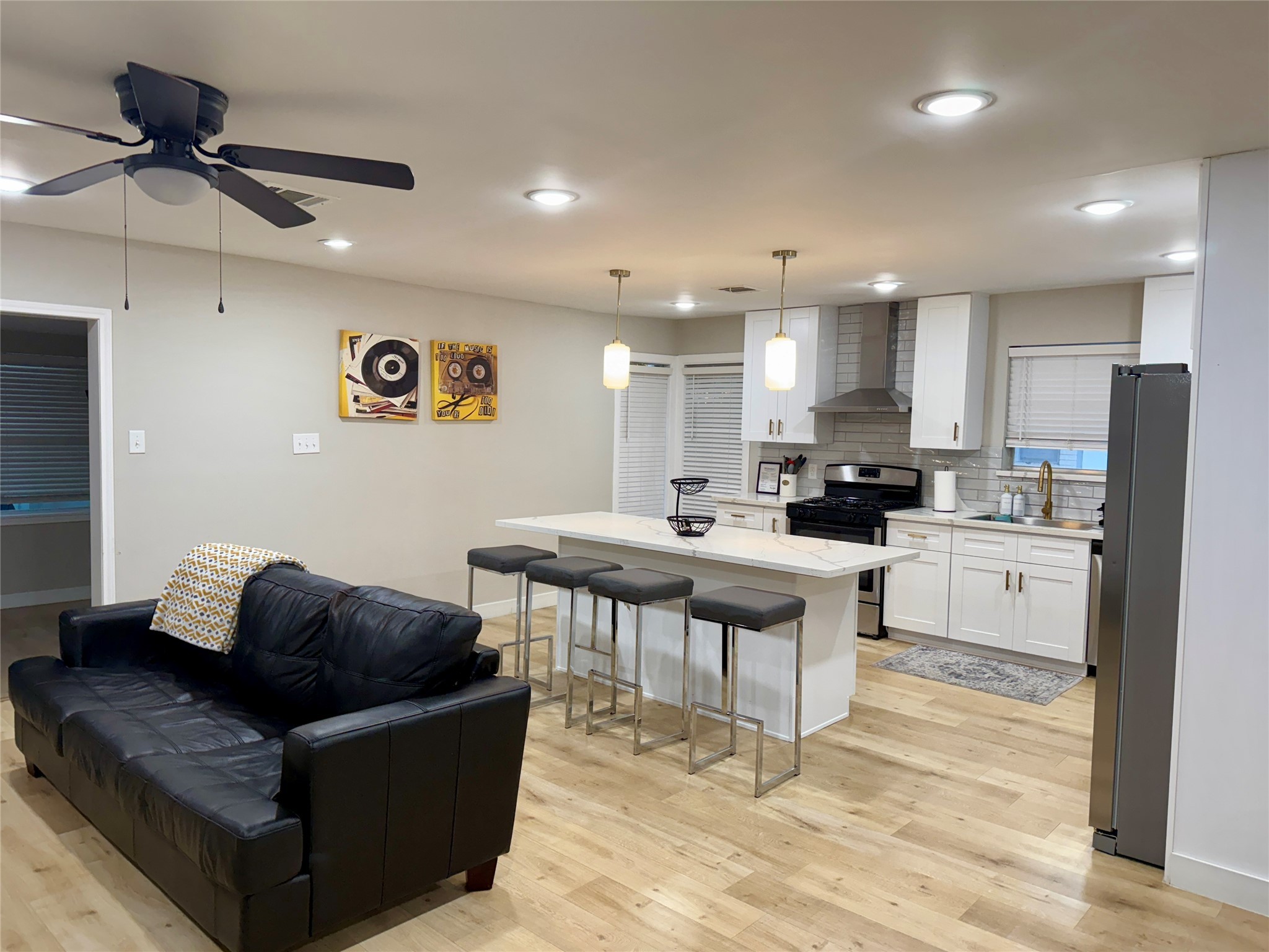 5455 Birdwood Road Houston, TX 77096 - Photo 3 of 26 a living room with stainless steel appliances kitchen island granite countertop a couch and a view of kitchen appliances