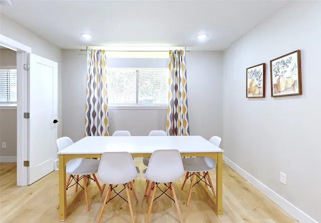 a view of a dining room with furniture and a window