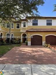 4972 Southwest 127th Avenue, Unit 4972 Miramar, FL 33027 - Photo 1 of 4 a front view of a house with a yard