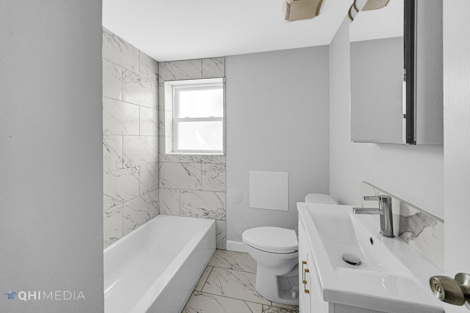 135 Custer Avenue, Unit 1 Evanston, IL 60202 - Photo 7 of 14 a bathroom with a sink a toilet and bathtub