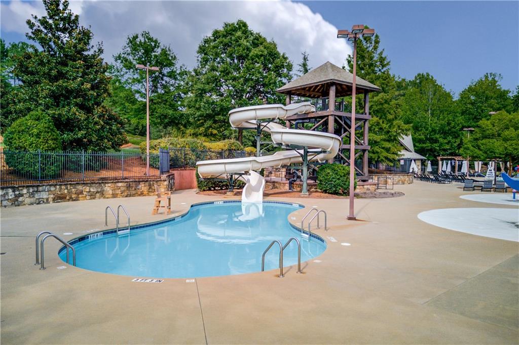 5004 Gunnison Trace Suwanee, GA 30024 - Photo 105 of 108 a view of a swimming pool with outdoor seating
