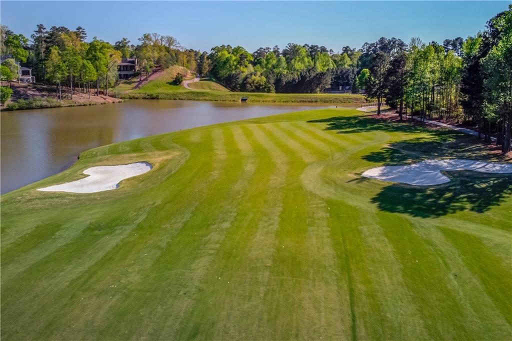 5004 Gunnison Trace Suwanee, GA 30024 - Photo 108 of 108 a view of a swimming pool with a yard and trees in the background