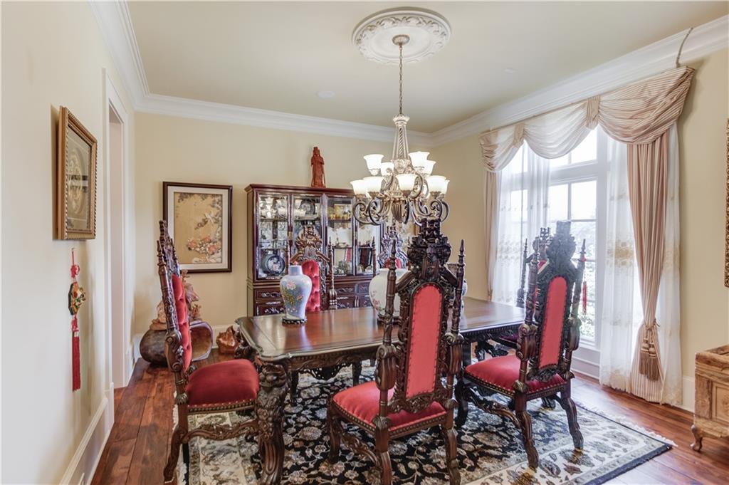 5004 Gunnison Trace Suwanee, GA 30024 - Photo 21 of 108 a view of a dining room with furniture and chandelier