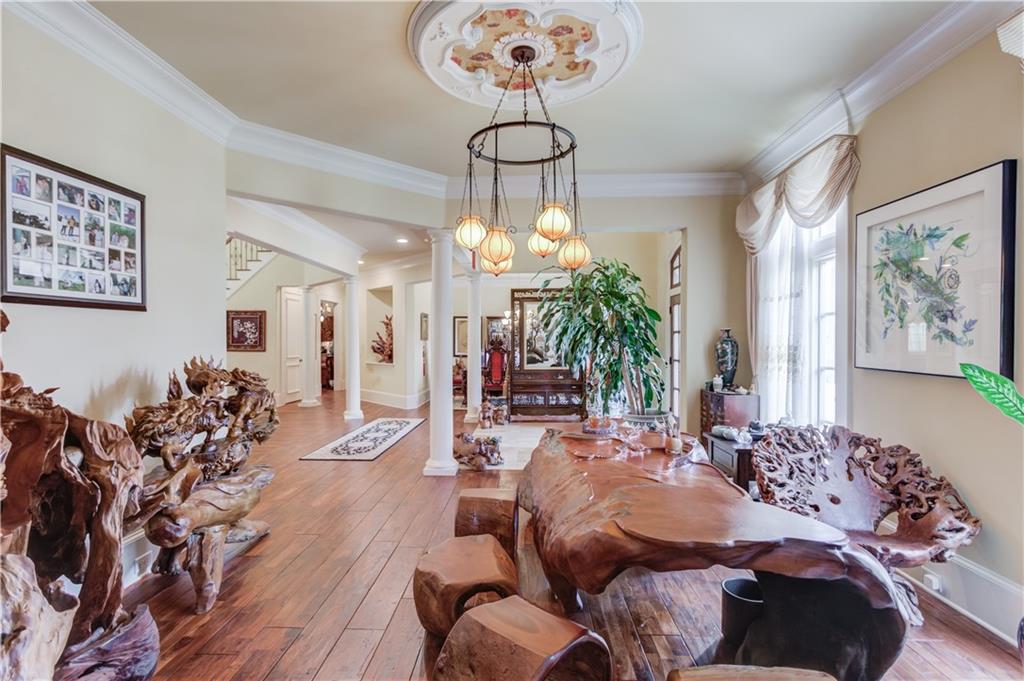5004 Gunnison Trace Suwanee, GA 30024 - Photo 25 of 108 a bedroom with furniture and a chandelier