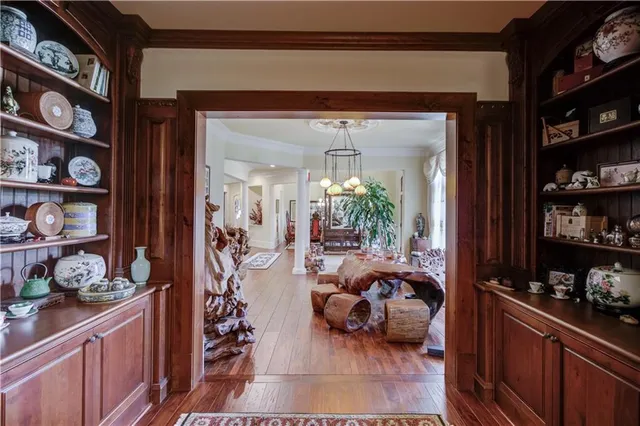 a bedroom with a large bed and a chandelier