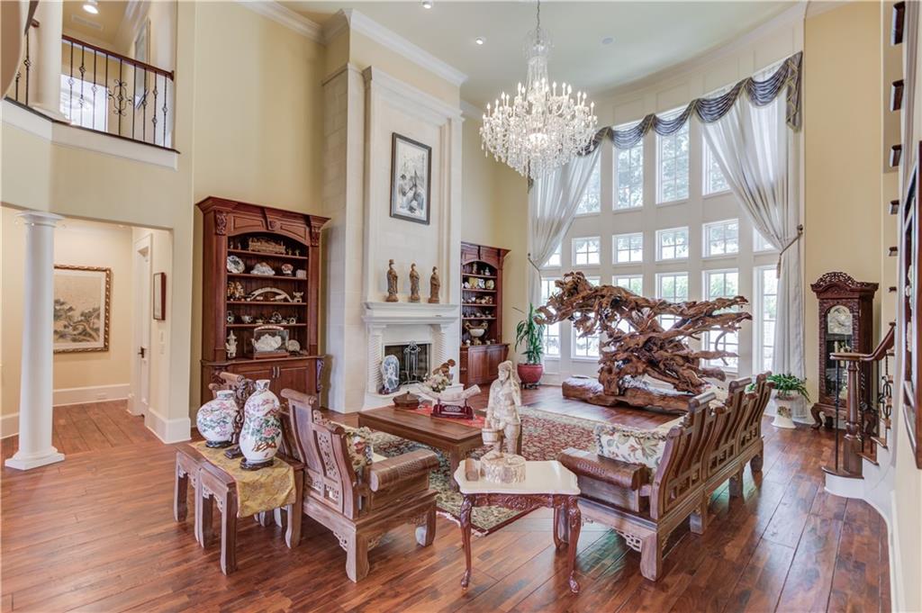 5004 Gunnison Trace Suwanee, GA 30024 - Photo 28 of 108 a view of a dining room with furniture a chandelier and wooden floor