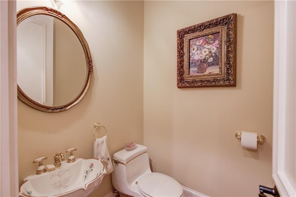 5004 Gunnison Trace Suwanee, GA 30024 - Photo 42 of 108 a bathroom with a toilet a sink and a mirror