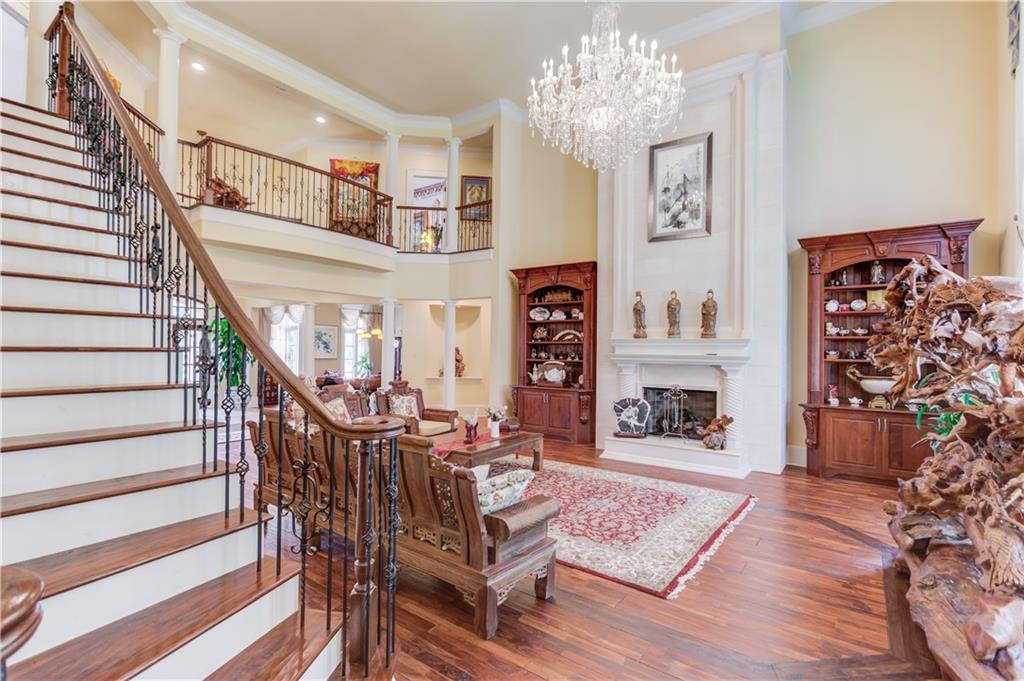 5004 Gunnison Trace Suwanee, GA 30024 - Photo 52 of 108 a view of a dining room with furniture wooden floor and a chandelier