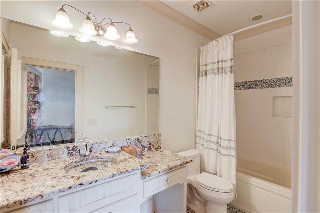 5004 Gunnison Trace Suwanee, GA 30024 - Photo 60 of 108 a bathroom with a granite countertop sink a toilet and a mirror