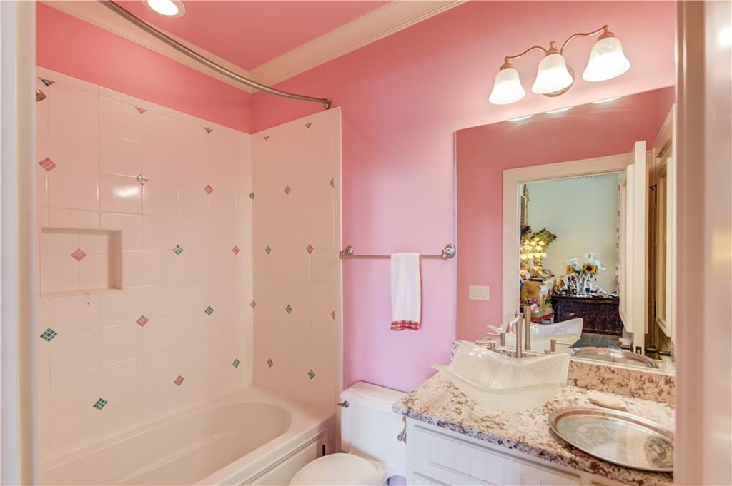 5004 Gunnison Trace Suwanee, GA 30024 - Photo 63 of 108 a bathroom with a granite countertop tub a sink and a large mirror
