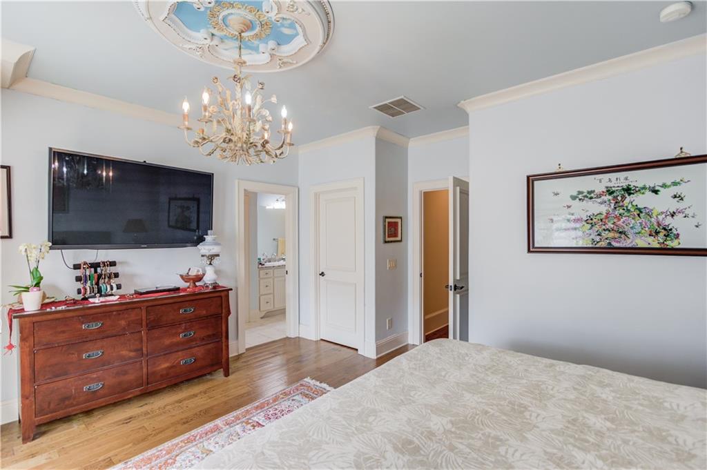 5004 Gunnison Trace Suwanee, GA 30024 - Photo 65 of 108 a spacious bedroom with a bed and a flat screen tv