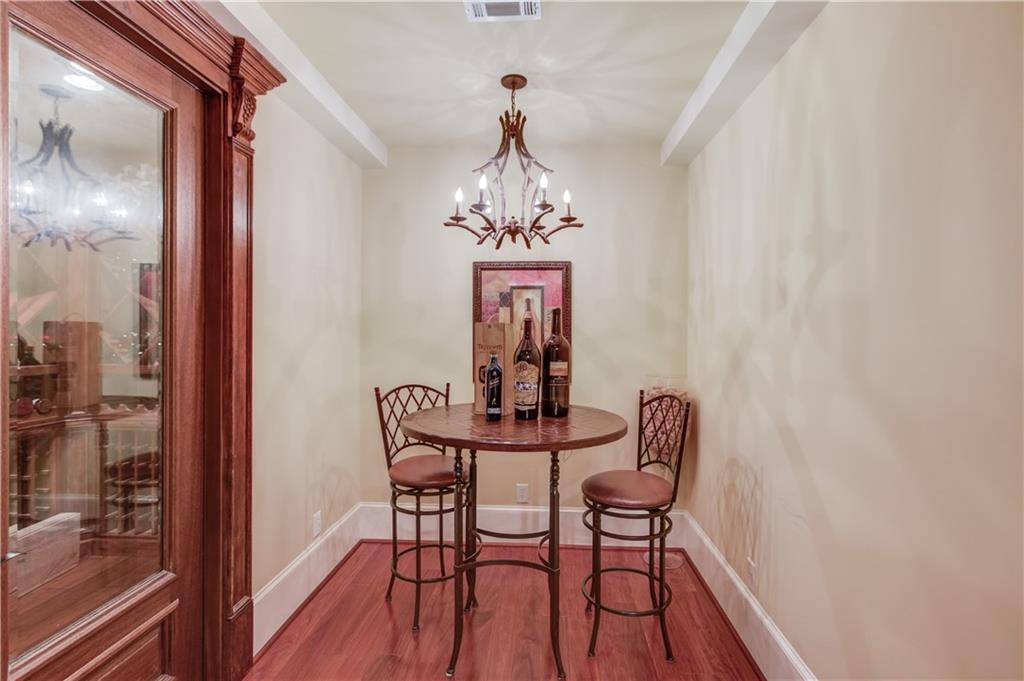 5004 Gunnison Trace Suwanee, GA 30024 - Photo 74 of 108 a view of a dining room with furniture wooden floor and a chandelier