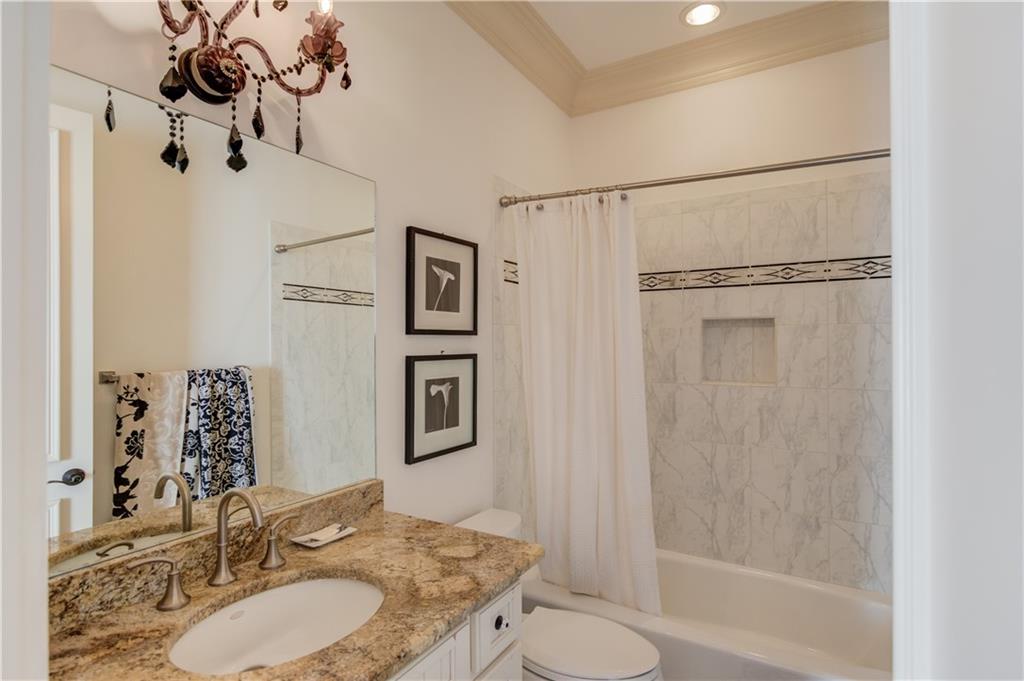 5004 Gunnison Trace Suwanee, GA 30024 - Photo 91 of 108 a bathroom with a granite countertop sink toilet a mirror a vanity and shower